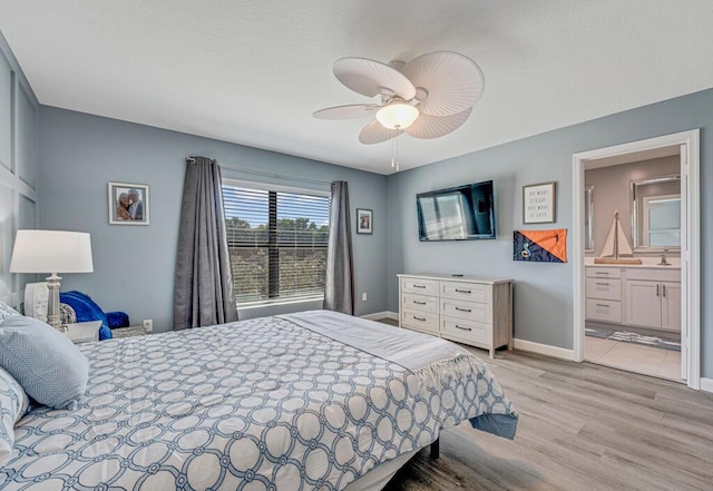 1012 Willow Pl, Riviera Beach, FL 33410 - bedroom featuring light wood-style floors, baseboards, a ceiling fan, and ensuite bathroom
