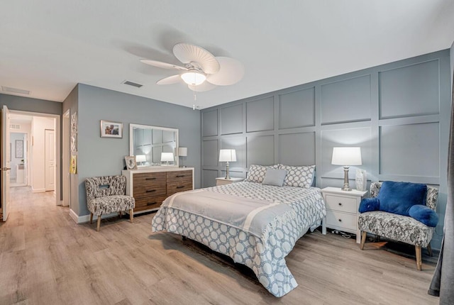 1012 Willow Pl, Riviera Beach, FL 33410 - bedroom with a decorative wall, light wood-type flooring, and ceiling fan