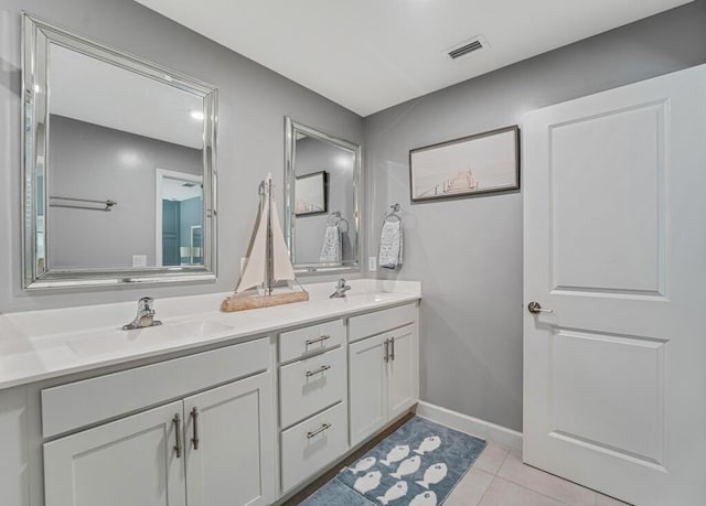 1012 Willow Pl, Riviera Beach, FL 33410 - bathroom with double vanity, tile patterned flooring, and baseboards