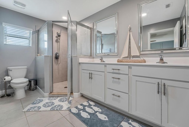 1012 Willow Pl, Riviera Beach, FL 33410 - bathroom with a shower stall, toilet, tile patterned floors, and double vanity