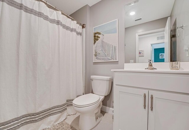 1012 Willow Pl, Riviera Beach, FL 33410 - bathroom featuring toilet, vanity, baseboards, and tile patterned floors