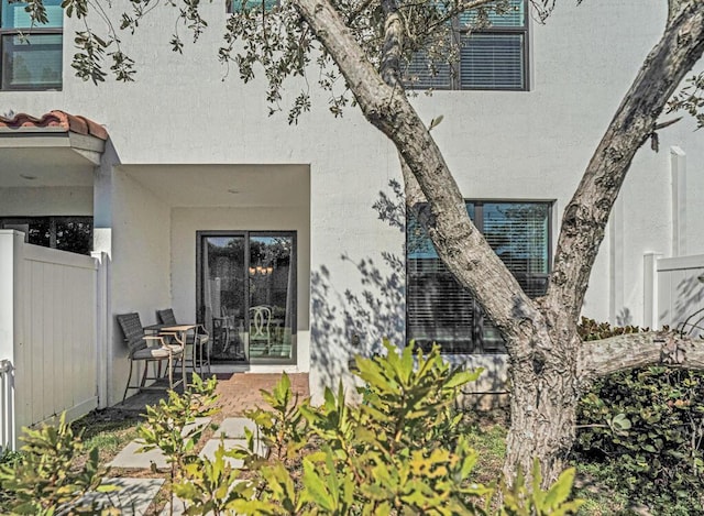 1012 Willow Pl, Riviera Beach, FL 33410 - view of exterior entry with stucco siding, fence, and a patio area