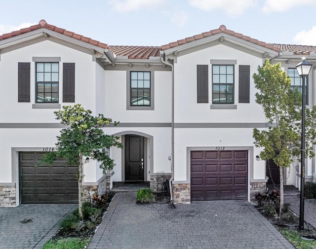 1012 Willow Pl, Riviera Beach, FL 33410 - view of front facade with a garage, decorative driveway, stucco siding, and stone siding
