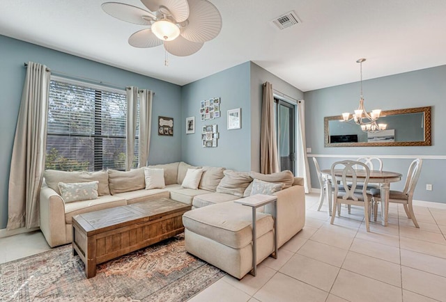 1012 Willow Pl, Riviera Beach, FL 33410 - living room with a chandelier, light tile patterned flooring, ceiling fan, and baseboards