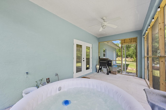 7633 NW 93rd Ct, Okeechobee, FL 34972 - sunroom with a jacuzzi, french doors, and a ceiling fan