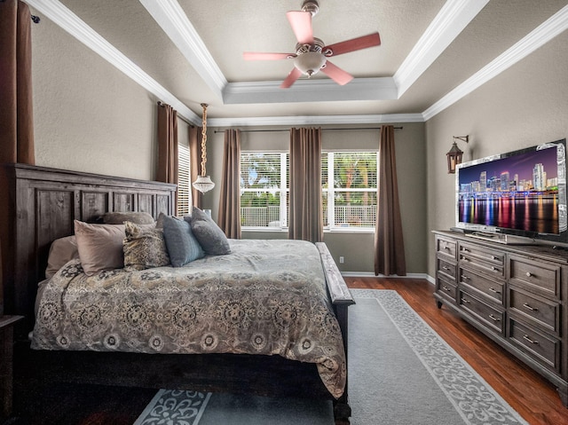 1289 Beacon Cir, Wellington, FL 33414 - bedroom with ornamental molding, dark wood-style floors, a tray ceiling, a ceiling fan, and baseboards