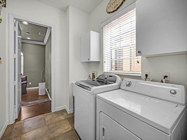 1289 Beacon Cir, Wellington, FL 33414 - washroom with cabinet space, washing machine and dryer, baseboards, and light stone finish flooring
