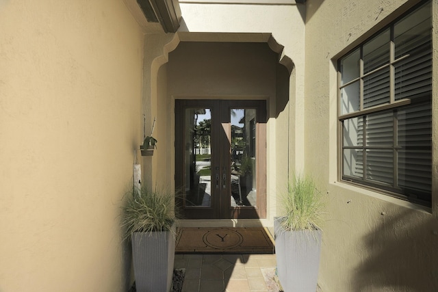 doorway to property with french doors and stucco siding