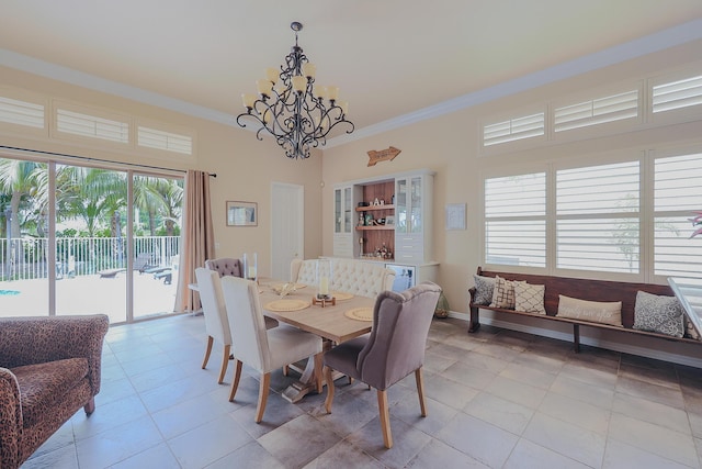 dining room featuring crown molding, an inviting chandelier, light tile patterned flooring, and plenty of natural light
