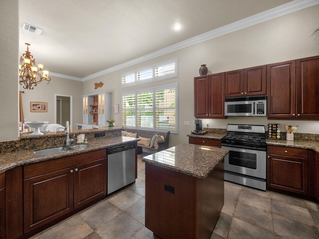 1289 Beacon Cir, Wellington, FL 33414 - kitchen featuring appliances with stainless steel finishes, a sink, crown molding, dark stone countertops, and a chandelier