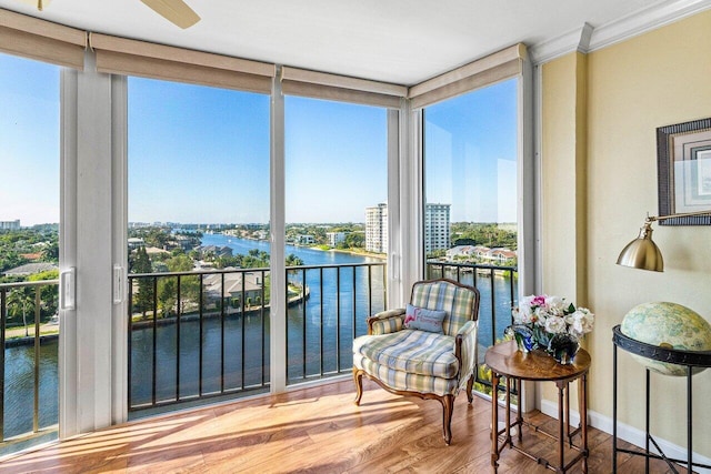 400 Seasage Dr Unit 904, Delray Beach, FL 33483 - sunroom / solarium featuring a water view, a wall of windows, crown molding, wood finished floors, and baseboards