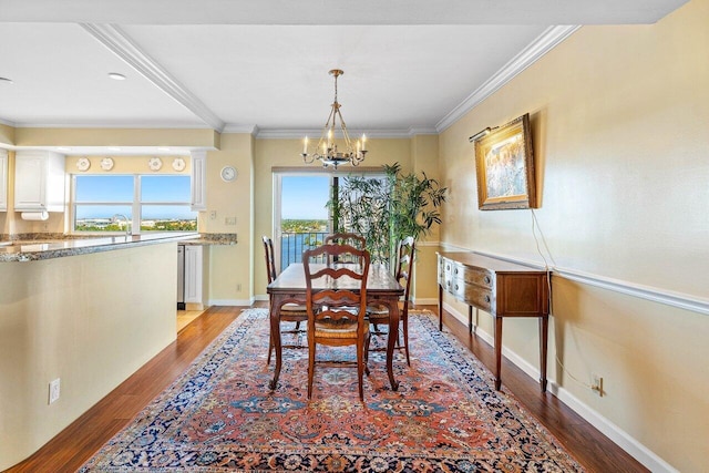 400 Seasage Dr Unit 904, Delray Beach, FL 33483 - dining space featuring light wood-style floors, a chandelier, ornamental molding, and baseboards