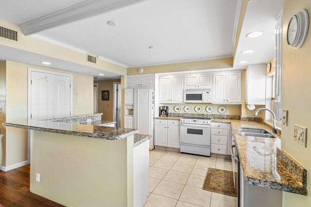 400 Seasage Dr Unit 904, Delray Beach, FL 33483 - kitchen with white appliances, a sink, white cabinets, stone counters, and crown molding