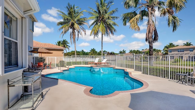 view of swimming pool featuring a fenced backyard, a pool with connected hot tub, and a patio area