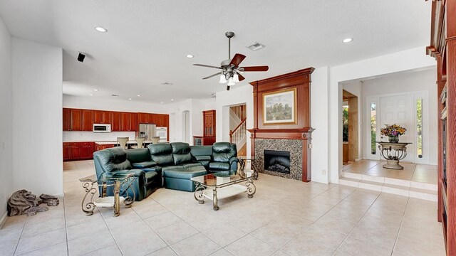 living area with recessed lighting, light tile patterned flooring, and visible vents