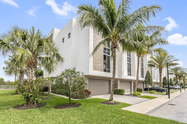 4240 NW 17th Ave, Boca Raton, FL 33431 - view of property with an attached garage and driveway