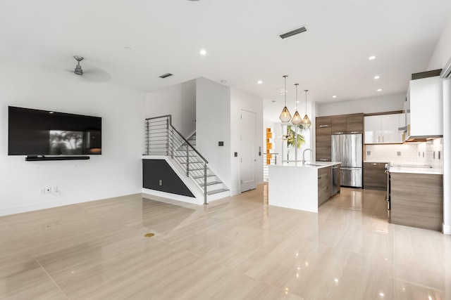 4240 NW 17th Ave, Boca Raton, FL 33431 - unfurnished living room featuring stairway, a sink, ceiling fan, recessed lighting, and baseboards