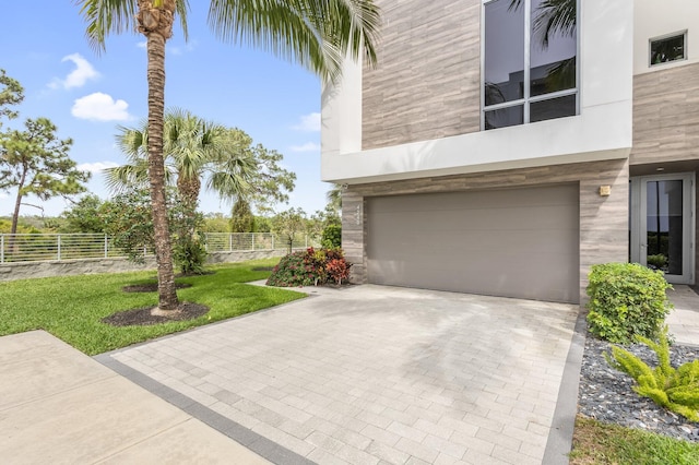 4240 NW 17th Ave, Boca Raton, FL 33431 - view of side of home featuring a garage, decorative driveway, and stucco siding