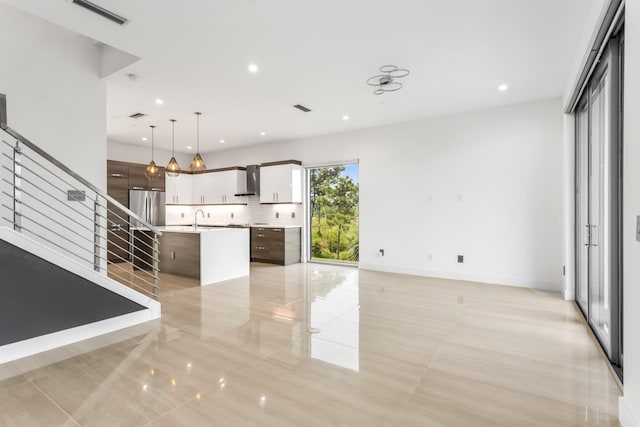 4240 NW 17th Ave, Boca Raton, FL 33431 - unfurnished living room featuring stairway, recessed lighting, and a sink
