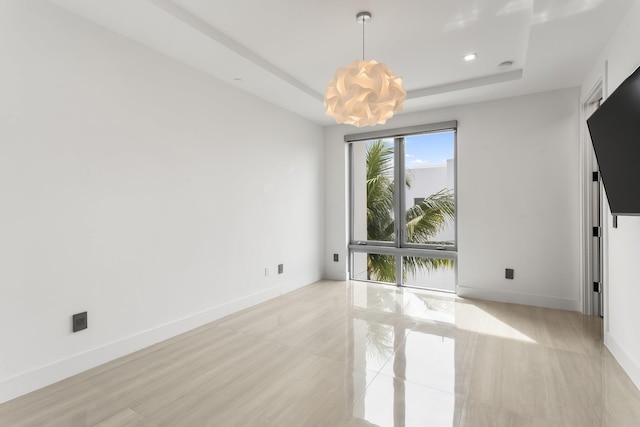 4240 NW 17th Ave, Boca Raton, FL 33431 - unfurnished room featuring a chandelier, baseboards, and a tray ceiling