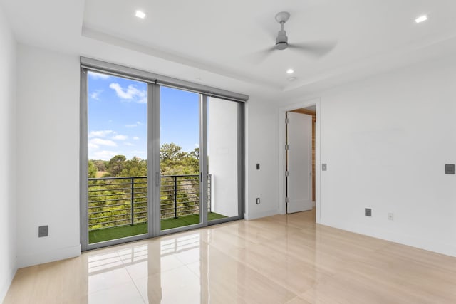 4240 NW 17th Ave, Boca Raton, FL 33431 - spare room featuring plenty of natural light, a raised ceiling, a ceiling fan, and recessed lighting