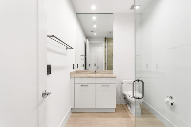 4240 NW 17th Ave, Boca Raton, FL 33431 - full bathroom with wood finished floors, vanity, toilet, recessed lighting, and a shower stall