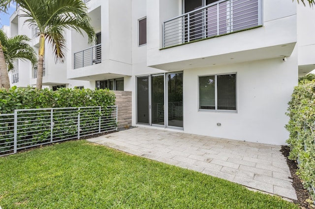 4240 NW 17th Ave, Boca Raton, FL 33431 - rear view of property with stucco siding, a yard, and a patio area