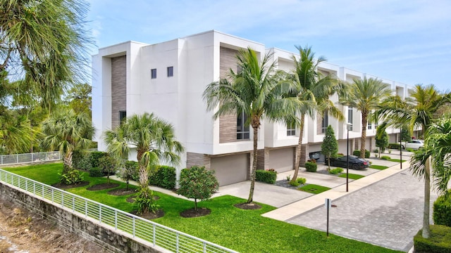 4240 NW 17th Ave, Boca Raton, FL 33431 - view of property featuring driveway, a garage, and fence
