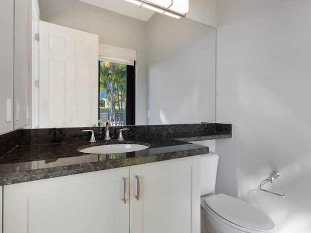 bathroom with toilet and vanity