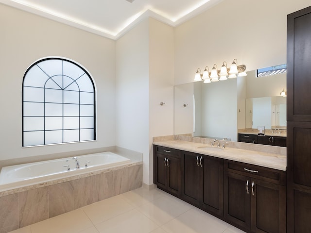 full bath featuring vanity, a garden tub, and tile patterned floors