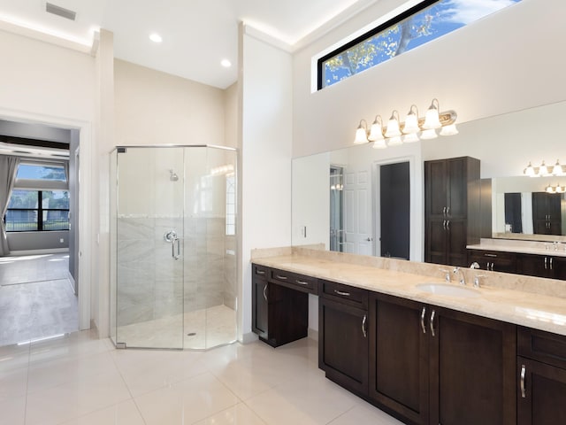 full bathroom featuring tile patterned flooring, visible vents, a stall shower, a towering ceiling, and vanity