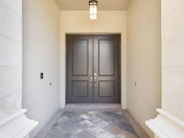 doorway to property with stucco siding and french doors