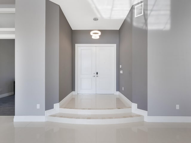entrance foyer featuring tile patterned flooring, baseboards, and visible vents