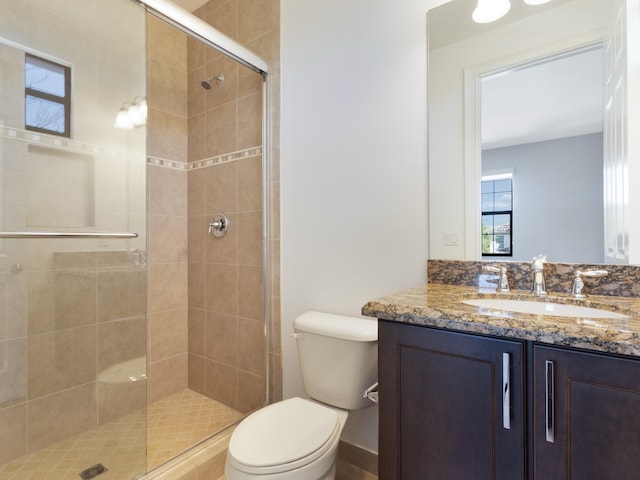 full bathroom with toilet, a stall shower, and vanity