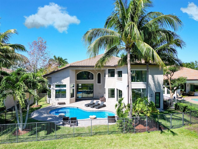 view of swimming pool with a yard, a fenced in pool, a patio, and a fenced backyard