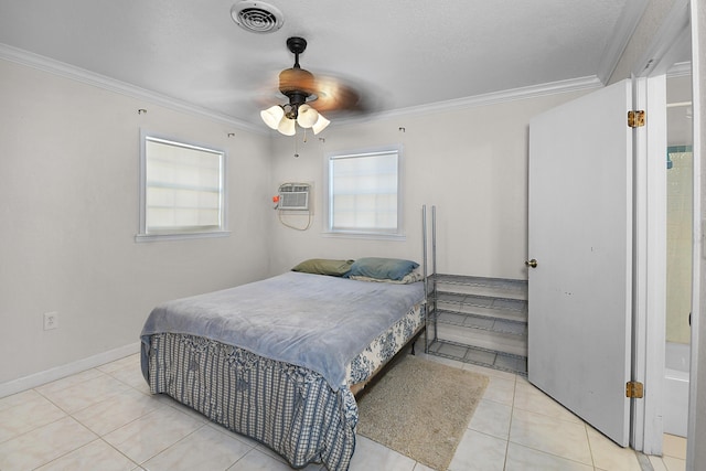 bedroom with visible vents, crown molding, baseboards, tile patterned floors, and a wall unit AC