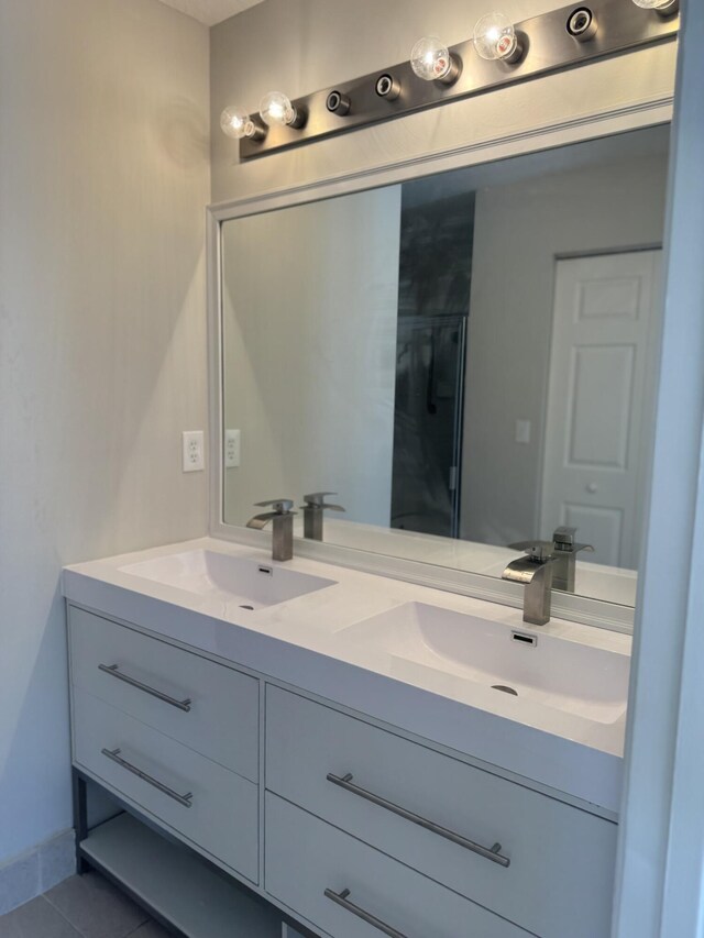 full bath with double vanity and tile patterned flooring