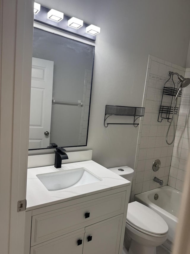 bathroom featuring toilet, bathtub / shower combination, and vanity