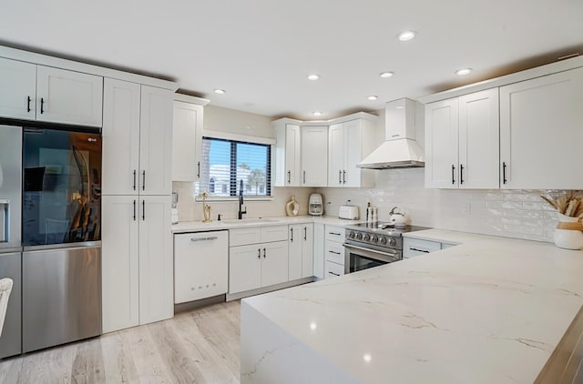 7527 Glendevon Ln Unit 805, Delray Beach, FL 33446 - kitchen with light stone counters, white cabinetry, custom range hood, stainless steel appliances, and backsplash