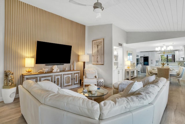 7527 Glendevon Ln Unit 805, Delray Beach, FL 33446 - living area featuring light wood finished floors, visible vents, lofted ceiling, and ceiling fan with notable chandelier