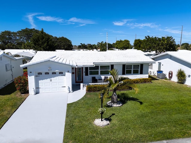 ranch-style house featuring an attached garage, concrete driveway, a front lawn, and cooling unit