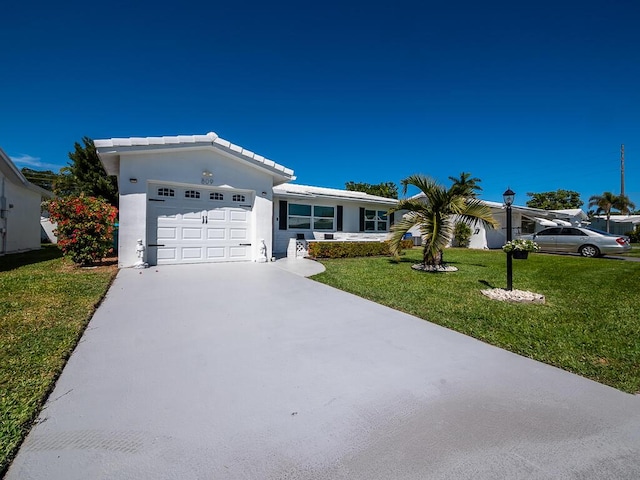 ranch-style house with an attached garage, stucco siding, a tile roof, concrete driveway, and a front lawn