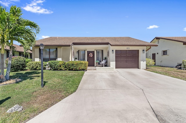 ranch-style home with a garage, stucco siding, driveway, and a front yard