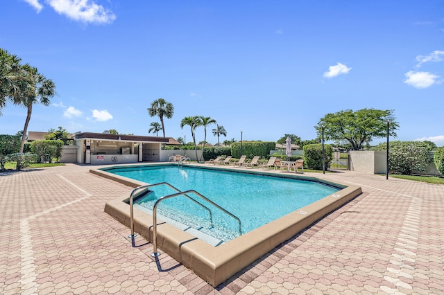 pool featuring a patio area and fence