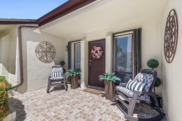 view of exterior entry with stucco siding