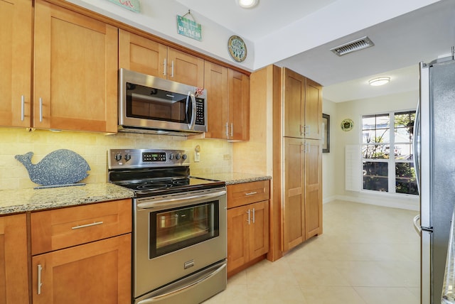 213 Ocean Dunes Cir, Jupiter, FL 33477 - kitchen with backsplash, stainless steel appliances, light stone counters, and visible vents