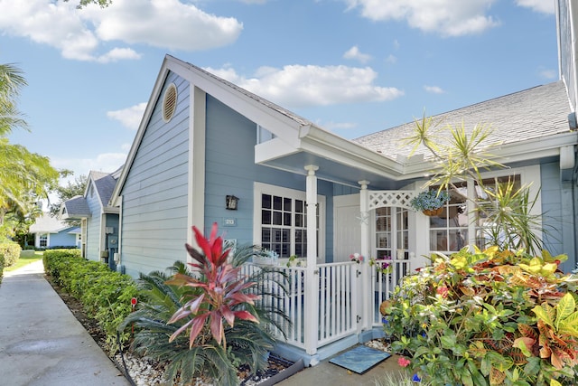 213 Ocean Dunes Cir, Jupiter, FL 33477 - exterior space featuring a shingled roof and a porch
