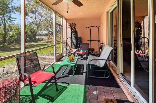 sunroom / solarium featuring ceiling fan