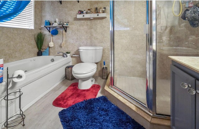 full bath featuring a shower stall, toilet, wood finished floors, a bath, and vanity