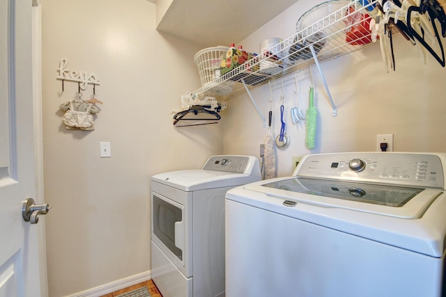12693 Coral Breeze Dr, Wellington, FL 33414 - washroom with baseboards, washing machine and dryer, and laundry area